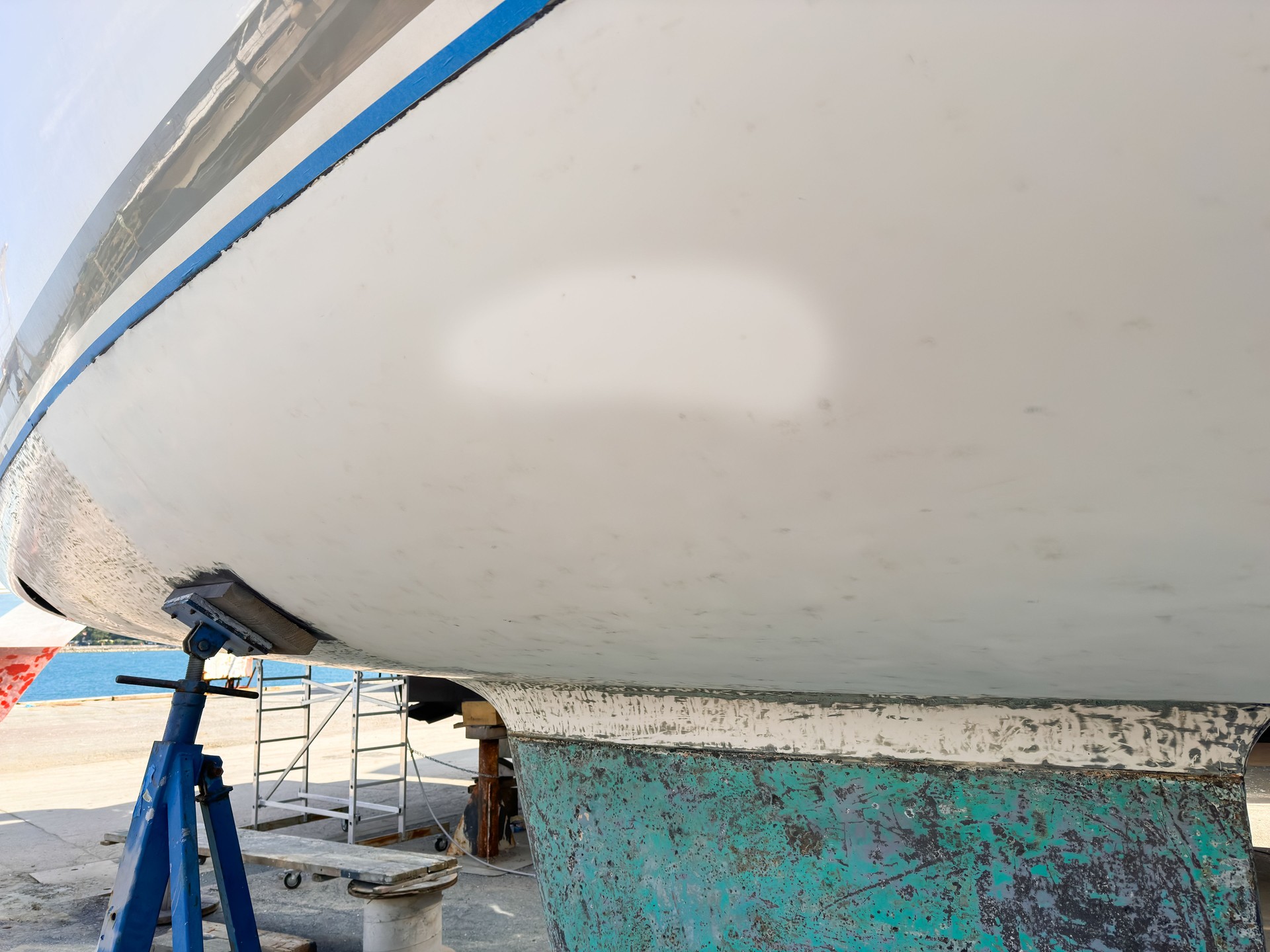 Removed antifouling paint with scraper from sailboat keel and hull